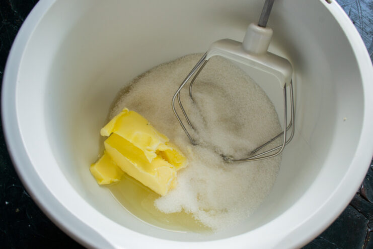 Step 1: Starting the Pie Batter with Sugar A glass bowl with granulated sugar being poured into it for the pie batter.