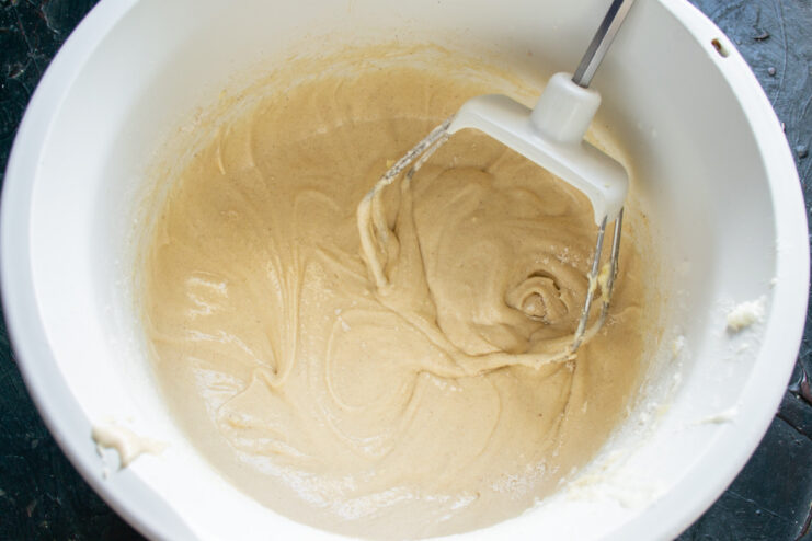 Step 2: Mixing the Dry Ingredients for the Pie A white bowl containing flour, cinnamon, and other dry ingredients being mixed with a whisk.