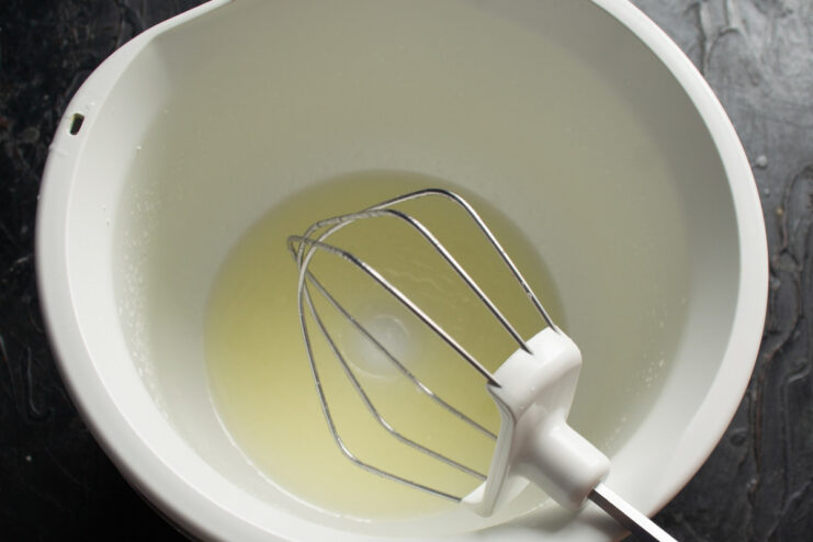 Step 1: Preparing the simple olive oil pie dough Liquid ingredients being mixed in a food processor bowl to start the pie dough.