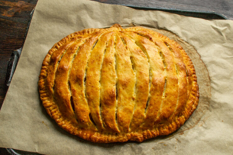 Baking the Pie Until Golden Brown The pumpkin-shaped pie baking in the oven, turning golden brown.