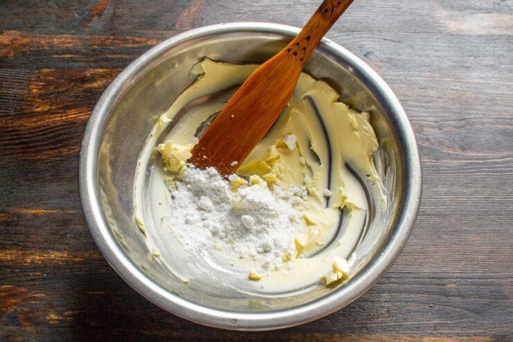 Creaming Butter and Sugar for the Pie Dough A bowl with softened butter and powdered sugar being mixed for the pie dough.