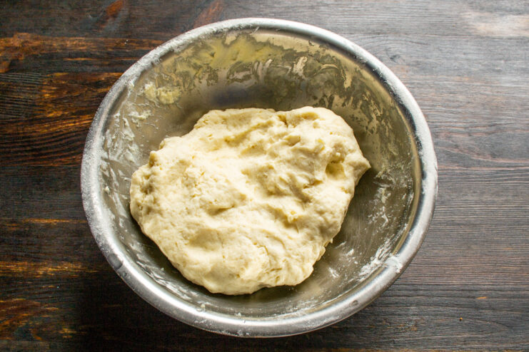 Chilling the Pie Dough Before Rolling A ball of pie dough wrapped in plastic wrap, ready to be chilled.