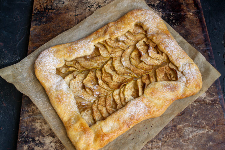 Dusting the Baked Apple Galette with Powdered Sugar Dusting the freshly baked Lenten apple galette with powdered sugar.