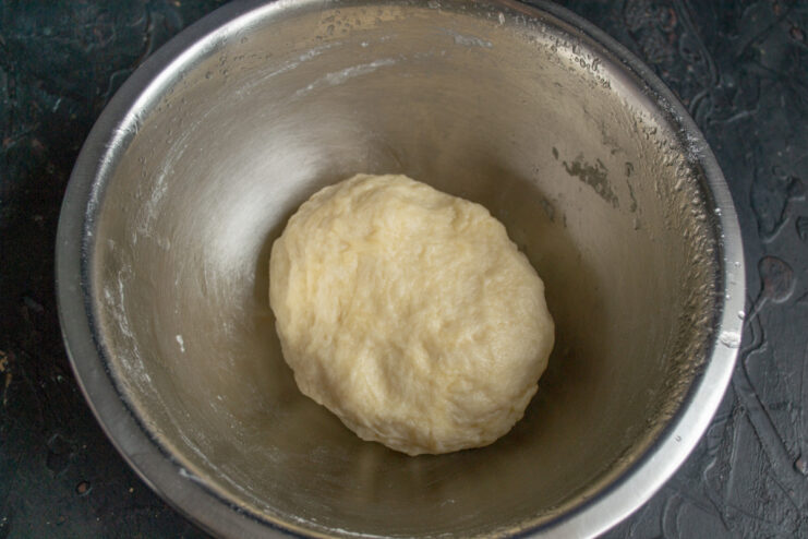 Kneading the Vegan Galette Dough on a Floured Surface Kneading the galette dough by hand on a lightly floured wooden board.