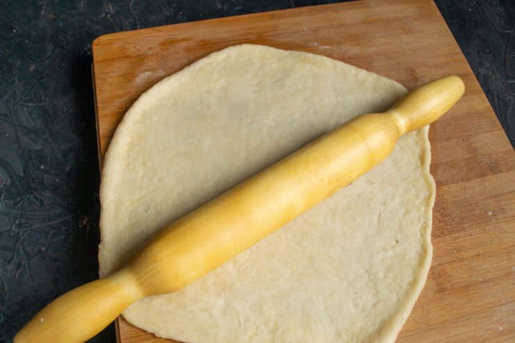 Rolling Out the Rested Dough for the Apple Galette Rolling out the rested galette dough into a large circle.