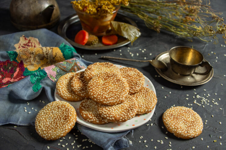 A plate of freshly baked Lenten cookies with pickle brine, sprinkled with sesame seeds.