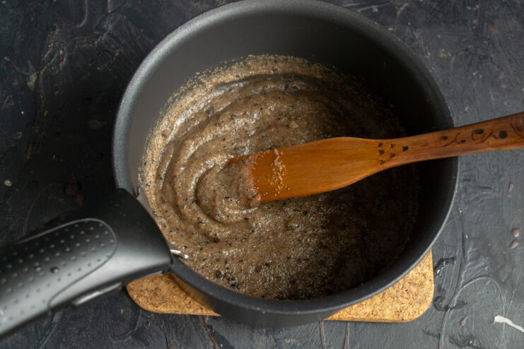 Cooking Semolina Porridge as a Binder for Patties Semolina being poured into a pot of boiling water and stirred to make a thick porridge.