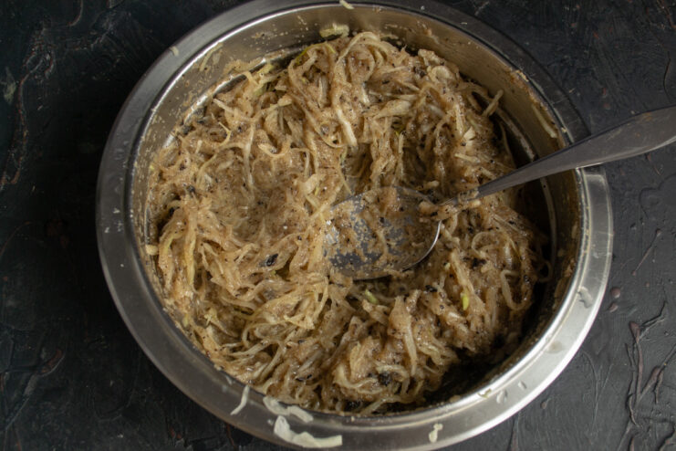 Mixing the Cabbage Patty 'Dough' Thoroughly Mixing shredded cabbage and semolina in a bowl to form the patty mixture.