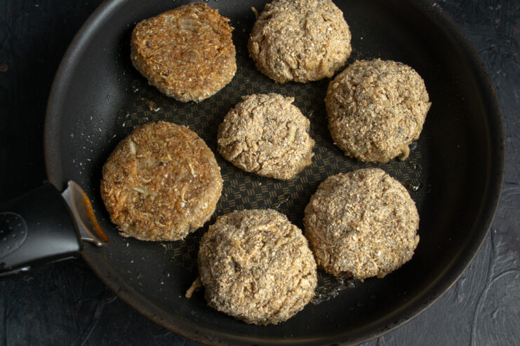 Frying the Cabbage Patties Until Golden Brown Cabbage patties frying in a pan until they are golden brown and crispy.