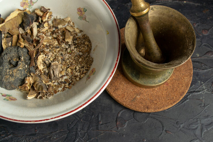 Making Mushroom Powder for Extra Flavor Dried porcini mushrooms being ground into a fine powder using a mortar and pestle.