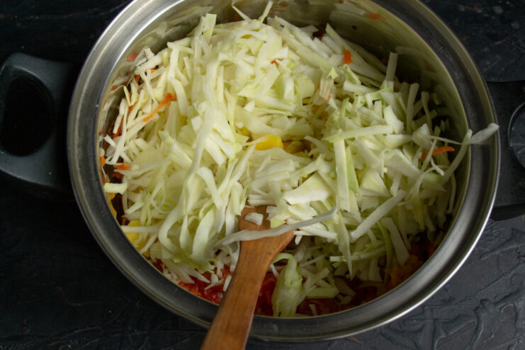 Shredding Cabbage for the Borscht A pile of thinly shredded white cabbage, ready to be added to the borscht.
