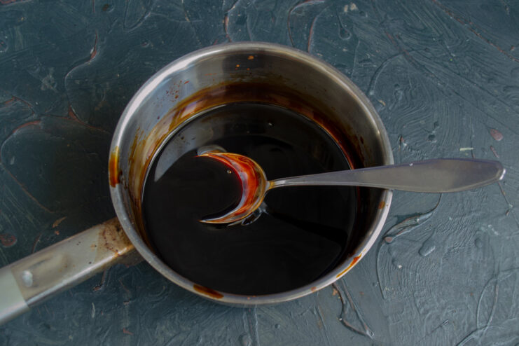Teriyaki sauce simmering and thickening in a saucepan.