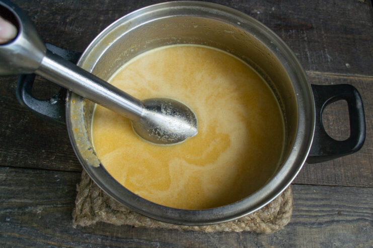 The Secret to a Creamy Soup: Blending the Broth Using an immersion blender to puree cooked vegetables directly in the pot of broth.