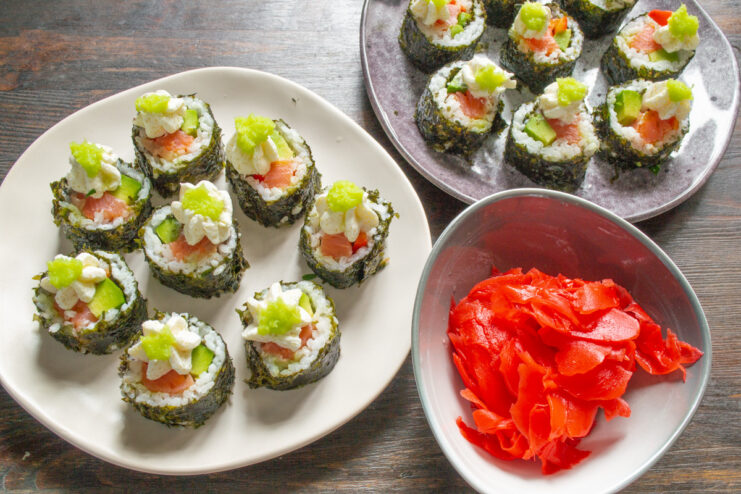 Serving the Freshly Made Sushi Rolls A platter of salmon, avocado, and bell pepper rolls ready to be served.