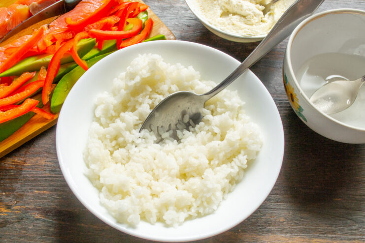 Making the Creamy Roe Topping A bowl with creamy curd cheese being mixed with orange herring roe.