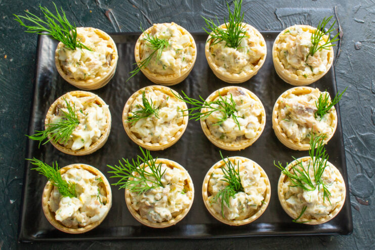 Preparing Dill Garnish for the Tartlets Small sprigs of fresh dill being prepared to garnish the salmon tartlets.