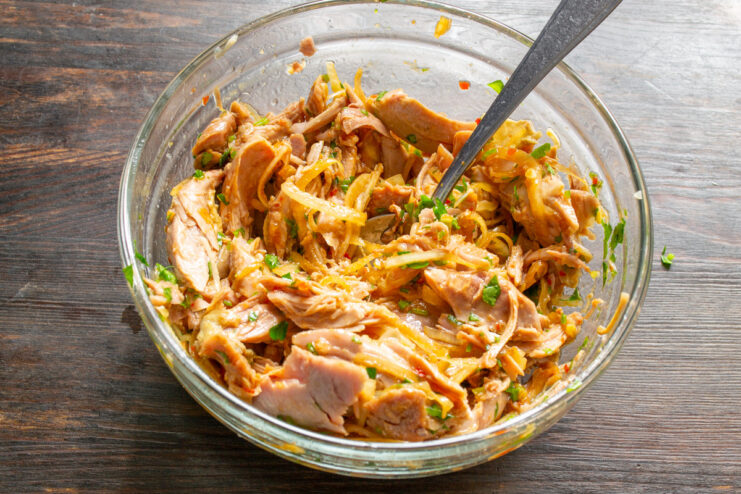 Chilling the Salad to Let Flavors Meld A bowl of turkey salad covered with plastic wrap, ready to be refrigerated.