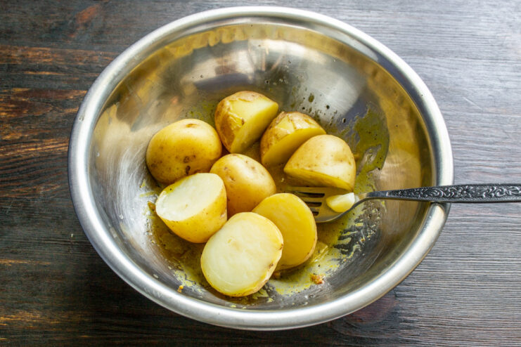 Tossing warm potatoes in the dressing allows them to absorb all the flavor. Tossing warm boiled new potatoes with the dressing in a large bowl.