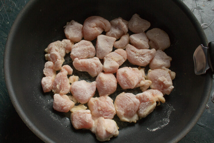 Frying the Turkey in a Wok until Perfectly Golden and Crispy Coated turkey pieces frying in a wok until golden brown.