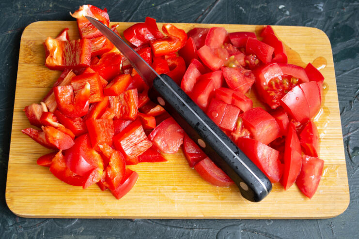 Diced red bell peppers in a bowl, ready for the salad recipe.