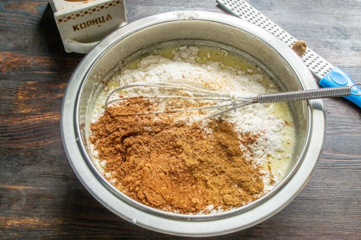 Step 4: Adding dry ingredients like flour to the wet mixture Sifting all-purpose flour into the bowl with the wet muffin batter ingredients.