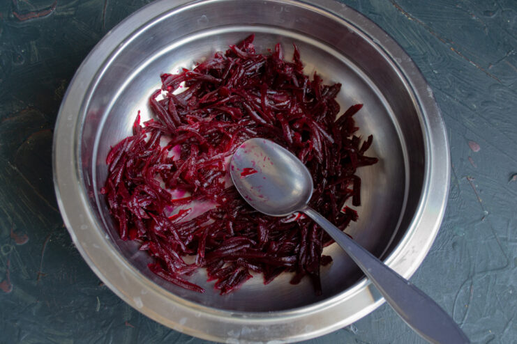 Preparing the Beetroot for the Brownie Batter Freshly grated beetroot in a white bowl, ready to be added to the brownie mix.