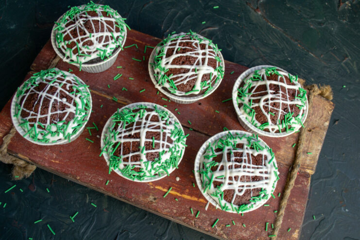 Final Touch: Adding Sprinkles to the Brownies Adding green sprinkles onto the wet white chocolate glaze of the beetroot brownies.