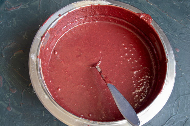 Blending the Batter for a Smooth Texture Using an immersion blender to create a smooth, homogenous beetroot brownie batter.