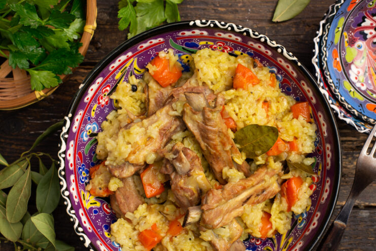 A deep plate filled with golden rice and tender pork ribs, ready to be served.