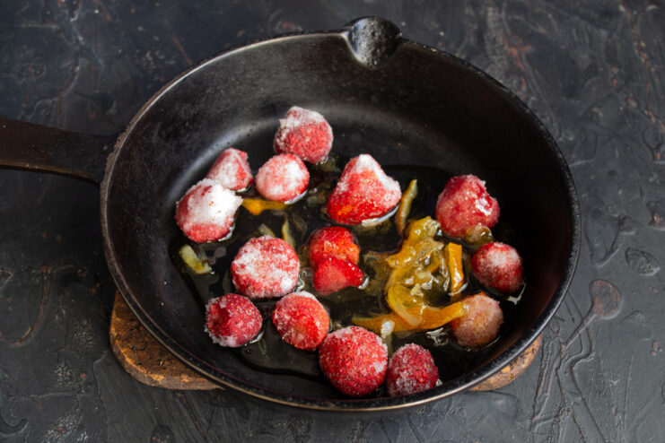 Making a Quick Strawberry Sauce Frozen strawberries and lemon jam in a saucepan to make the sauce.