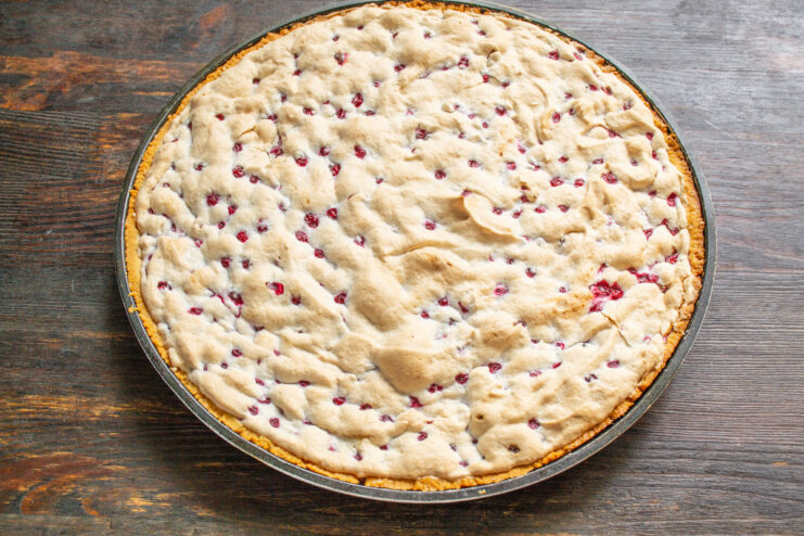 Baking the Tart to Golden Perfection A freshly baked redcurrant tart with a beautifully golden-brown meringue topping.