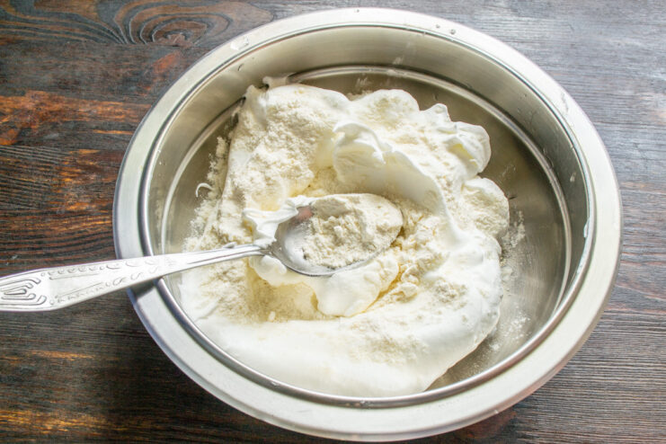 Whipping Egg Whites for Meringue Filling Electric mixer whipping egg whites and sugar in a bowl to create a glossy meringue.