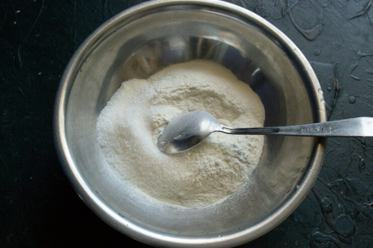 Combining Dry Ingredients for Shortcrust Pastry A bowl with flour and sugar, the first step for making shortcrust pastry.