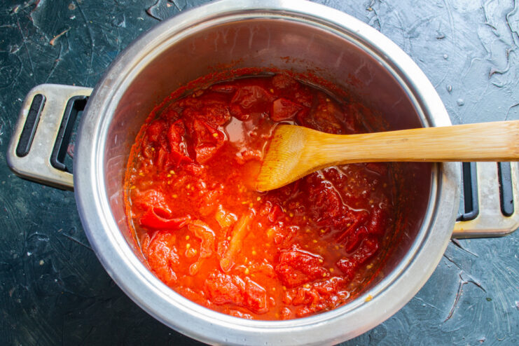 Cooking Down the Tomatoes: The First Step to a Smooth Sauce Steamed and softened tomatoes bubbling in a large pot on the stove.
