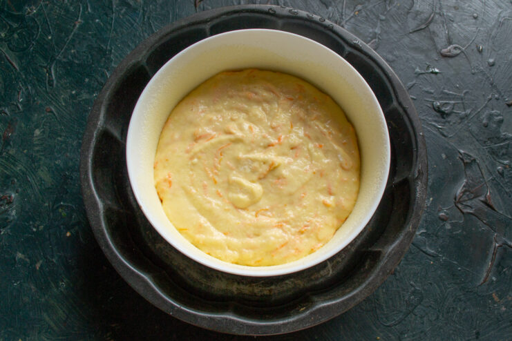 Setting Up a Water Bath (Bain-Marie) for Baking The glass baking dish with batter placed inside a larger rectangular pan to create a water bath.
