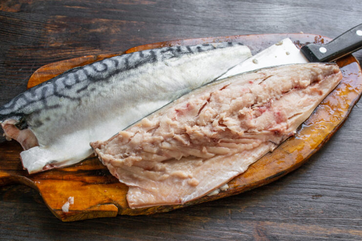 Step 2: Filleting the Mackerel for a Boneless Roll Two mackerel fillets separated from the backbone on a cutting board.