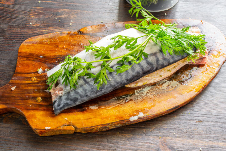 Step 4: Assembling the Mackerel Roll with Carrot Tops Inside Assembling the mackerel roll by placing fillets head-to-tail with carrot tops.