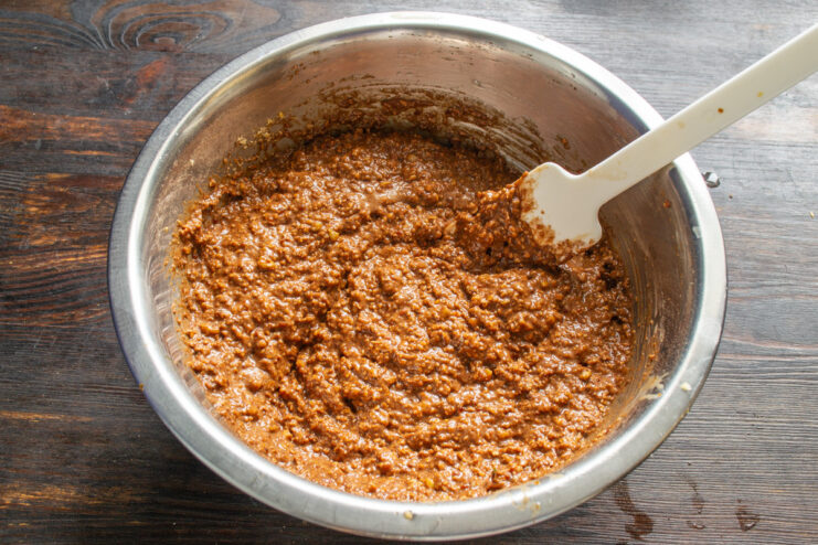 A bowl of mixed chocolate ginger cake batter, resting before being poured into the baking pan.