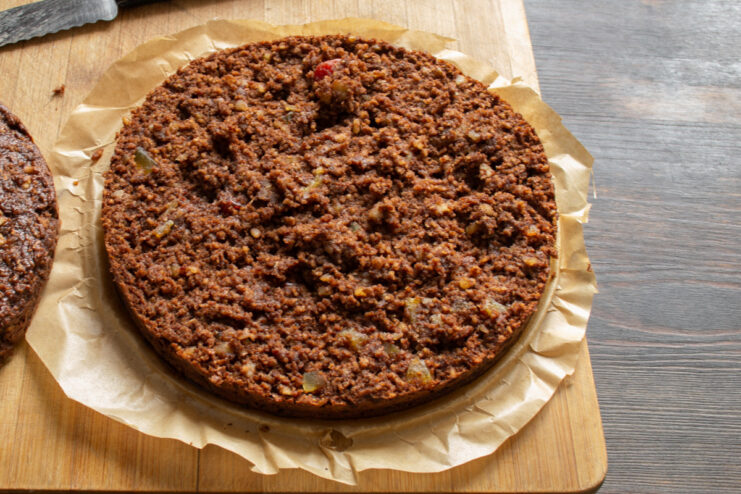 A cake pan with batter being placed into a preheated oven to bake.
