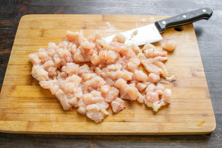 Step 1: Cubing the Cured Chicken Breast for the Ham A bowl of cubed raw chicken breast, salted and ready for seasoning.