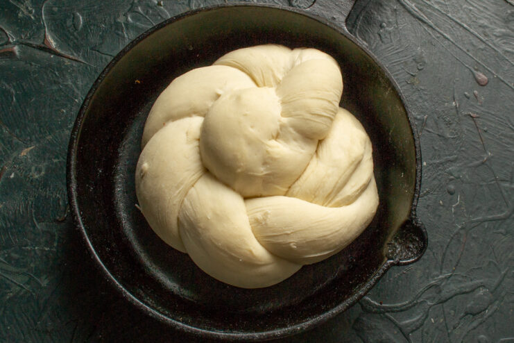 Step 12: Letting the Vitushka buns proof before baking. The shaped Vitushka bun covered with plastic wrap for its final proofing.