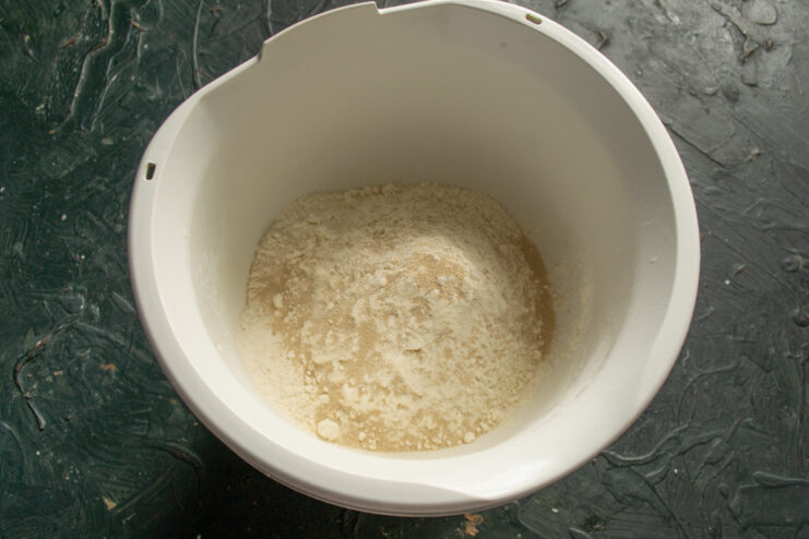 Step 2: Preparing the dry ingredients for the Vitushka dough. Sifting flour into a large mixing bowl for the sweet bun dough.