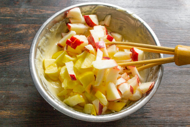 Preparing diced apples to add to the pie batter Fresh apples being diced into small cubes on a cutting board.