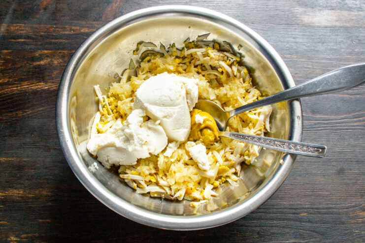 Making the Pâté Creamy with Soft Cheese Adding a generous amount of soft cream cheese to the bowl.