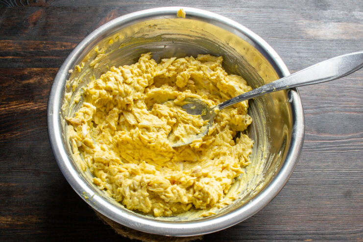 Finishing with Extra Virgin Olive Oil Drizzling extra virgin olive oil into the egg pâté mixture.
