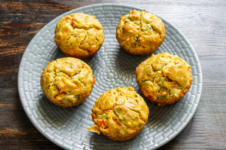 Freshly Baked Savory Muffins Cooling Before Serving Warm savory muffins being removed from silicone molds, ready to be served.