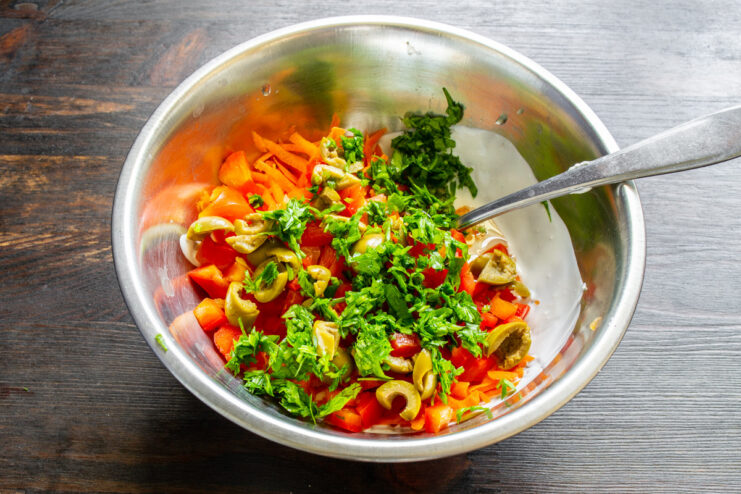 Adding Fresh Parsley for a Burst of Freshness Chopped fresh parsley being added to the muffin batter.