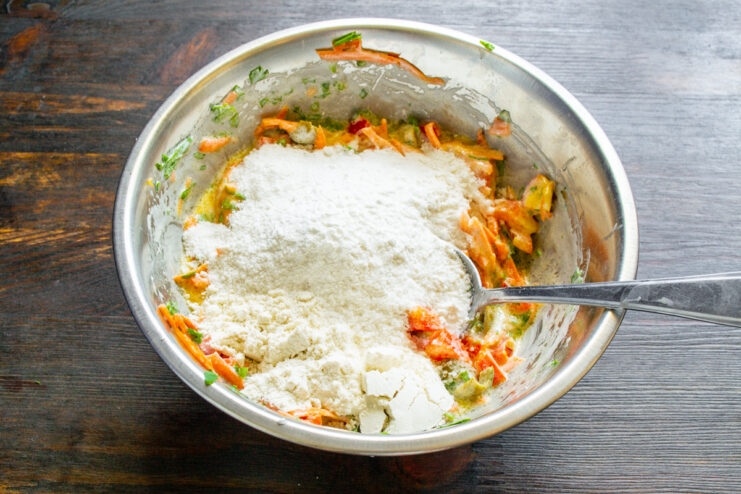 Combining Dry and Wet Ingredients for the Muffin Batter Pouring rice flour and other dry ingredients into the bowl with the wet vegetable mixture.