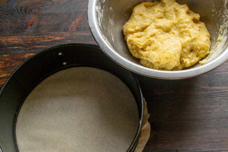 Lining the Springform Pan with Parchment Paper A springform pan with its base lined with a circle of parchment paper.