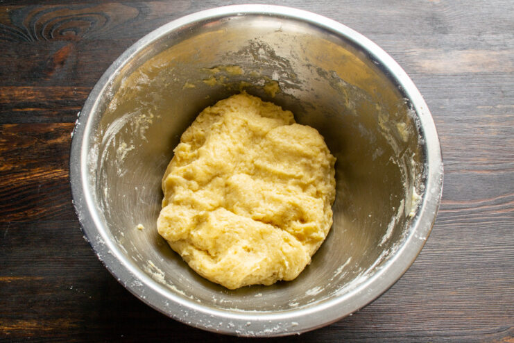 Kneading the Shortcrust Dough Hands quickly kneading the shortcrust pastry dough in a bowl.